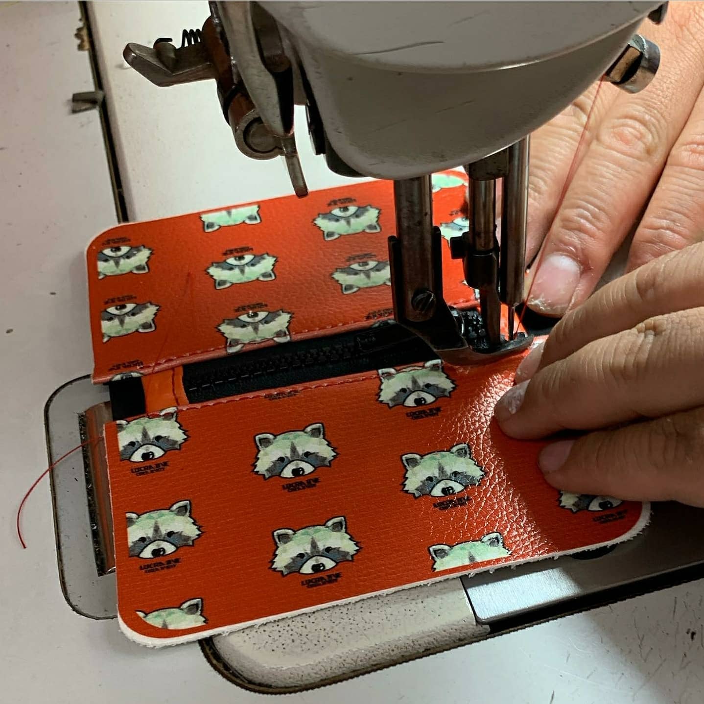 Lucrative Creativity patterned wallet being sewn