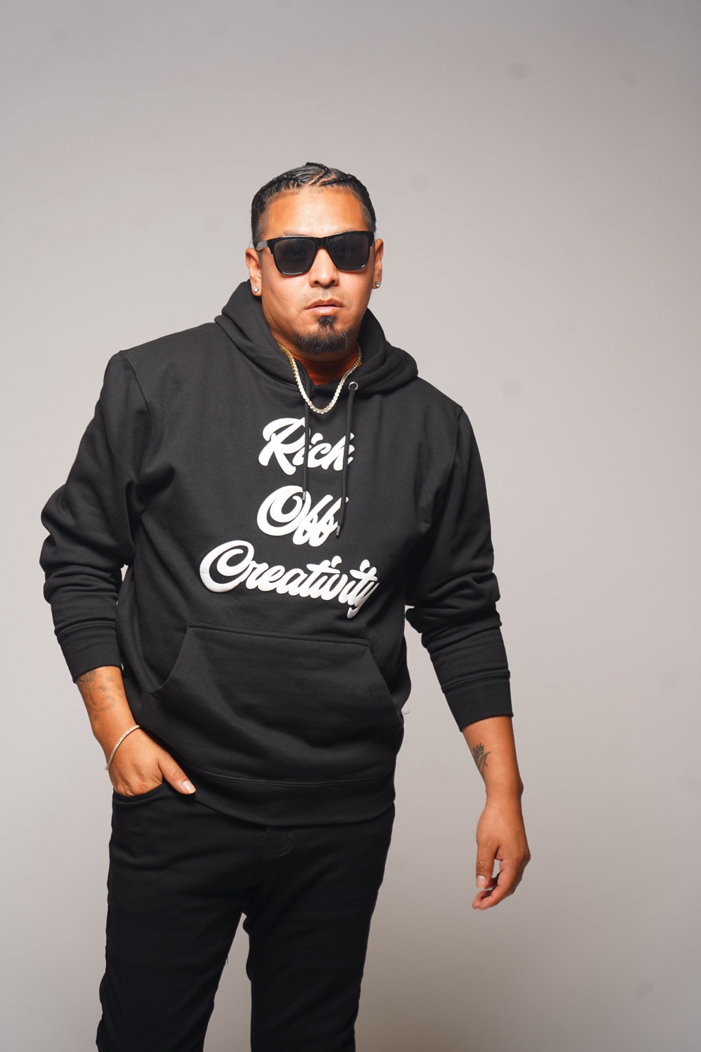 Model wearing the black Rich Off Creativity hoodie and sunglasses