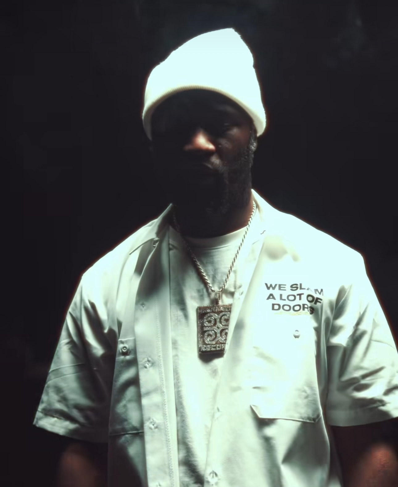 Creative wearing the white We Slam a Lot of Door$ work shirt after dark