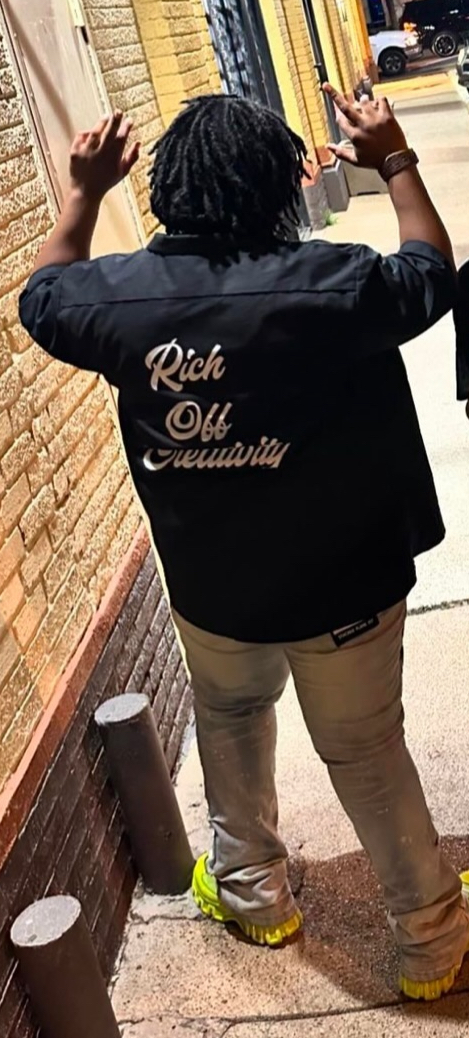 Creative showing the Rich Off Creativity script across a black work shirt